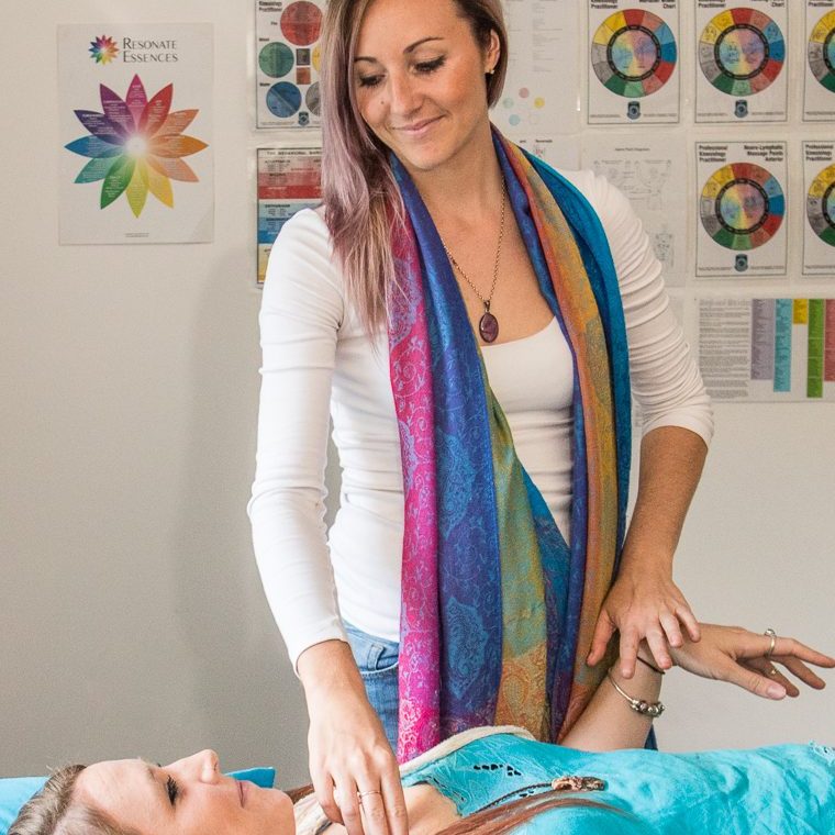 Kinesiologist working with a client on massage table